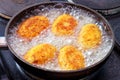 Croquettes frying in the oil, in action