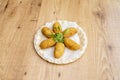 Croquettes stuffed with bÃÂ©chamel and chicken garnished with sprouts on recycled cardboard plate Royalty Free Stock Photo