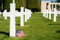 A cross and an american Flag in a military cemetery Royalty Free Stock Photo