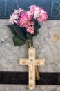 Cross and artifical flowers on a grave in Amalfi Cemetery, Amalfi Town, Campania, Italy