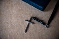 Cross and the Bible on brown paper background.