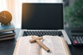 Cross on bible and laptop in online study bible concept. Holy Bible concept for modern religious education, podcast or help with Royalty Free Stock Photo