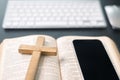 Cross on bible and laptop in online study bible concept. Holy Bible concept for modern religious education, podcast or help with Royalty Free Stock Photo