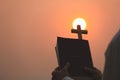 The cross and the bible, the symbol of Jesus` blessing, the symbol of supplication and faith, the symbol of the cross in the sky