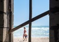 boards in the window overlooking the sea, the beach and the outgoing girl