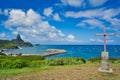 Cross on the top of mountain with beach and boats view