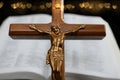 Cross with body of Jesus in front of open blurry Bibe and gold hearts Royalty Free Stock Photo