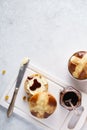 Cross buns with raisins, served with butter and jam for Easter