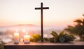 cross and candle placed on wooden table on mountain near ocean in sunrise light. Christian religion concept background.