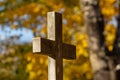 Cross in the cemetery on a sunny autumn day Royalty Free Stock Photo
