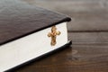 A cross with a chain next to a closed book Royalty Free Stock Photo