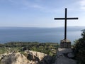 Cross on a cliff in park forest Marjan