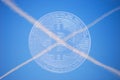 cross from contrails at the sky with a blue valueable bitcoin