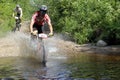 Cross country bike race. Overcoming a water obstacle.