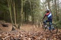 Cross-country cyclist drinking as he cycles in a forest Royalty Free Stock Photo