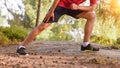 Cross country runner stretching Royalty Free Stock Photo