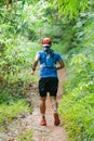 Cross country runner,Trail running in the forest,uphill in autumn trail of mud and stones,In the north of Thailand