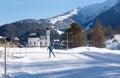 Cross-country skier on sunny track towards pitoresque church, Seefeld, Austria Royalty Free Stock Photo