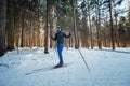 Cross-country skiing woman doing classic nordic cross country skiing in trail tracks in snow covered forest Royalty Free Stock Photo