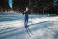 Cross-country skiing woman doing classic nordic cross country skiing in trail tracks in snow covered forest Royalty Free Stock Photo