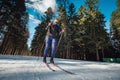 Cross-country skiing woman doing classic nordic cross country skiing in trail tracks in snow covered forest Royalty Free Stock Photo