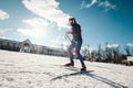 Cross-country skiing woman doing classic nordic cross country skiing in trail tracks in snow covered forest Royalty Free Stock Photo