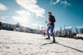 Cross-country skiing woman doing classic nordic cross country skiing in trail tracks in snow covered forest Royalty Free Stock Photo