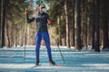 Cross-country skiing woman doing classic nordic cross country skiing in trail tracks in snow covered forest Royalty Free Stock Photo