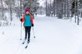 Cross country skiing - woman with skis on snowy forest ski track. Akaslompolo, Finland Royalty Free Stock Photo