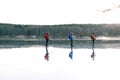 Cross-country tour skaters on frozen lake.