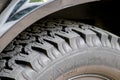 Cross-country vehicle for off road adventures in urban dirt tracks or all-terrain vehicle tire with grip and deep profile military Royalty Free Stock Photo