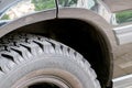 Cross-country vehicle for off road adventures in urban dirt tracks or all-terrain vehicle tire with grip and deep profile military Royalty Free Stock Photo