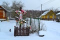 Cross on crossroad in village of Belarus in winter day. Old wooden cross