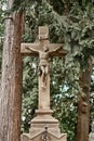 Cross with the crucifixions of Jesus Christ on the grave in the cemetery Royalty Free Stock Photo