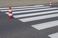 The cross-decorated pedestrian crossing with the still not dried out red. Restriction of traffic by road signs. Update road pedest Royalty Free Stock Photo