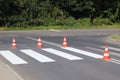 The cross-decorated pedestrian crossing with the still not dried out red. Restriction of traffic by road signs. Update road pedest Royalty Free Stock Photo