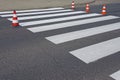 The cross-decorated pedestrian crossing with the still not dried out red. Restriction of traffic by road signs. Update road pedest Royalty Free Stock Photo
