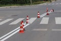 The cross-decorated pedestrian crossing with the still not dried out red. Restriction of traffic by road signs. Update road pedest Royalty Free Stock Photo