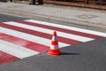 The cross-decorated pedestrian crossing with the still not dried out red. Restriction of traffic by road signs. Update road pedest Royalty Free Stock Photo