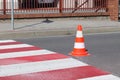 The cross-decorated pedestrian crossing with the still not dried out red. Restriction of traffic by road signs. Update road pedest Royalty Free Stock Photo