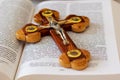 Cross depicting the crucifixion of Jesus Christ on the pages of the Holy Bible