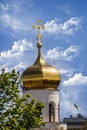 The cross and the dome of the church against the blue sky and clouds Royalty Free Stock Photo