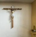 A cross at the entrance to the church and a droplet with holy water next to it Royalty Free Stock Photo