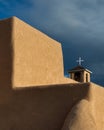 Cross framed by large adobe wall