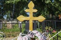 A cross on a fresh grave in a Christian cemetery. Close-up. Vertical