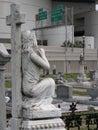 Cross and Funerary Statue and Cemetery with Interstate Roadsigns in the Background Royalty Free Stock Photo