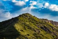 Cross on green mountain peak in Mtskheta, Georgia under dramatic cloudy sky Royalty Free Stock Photo