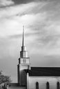 Cross high on top of a church steeple in the late afternoon Royalty Free Stock Photo