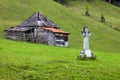 Cross and house in Romania mountain countryside