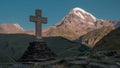 Cross in Kazbegi with view of mountain Kazbek Royalty Free Stock Photo